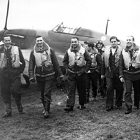 Pilots of 303 (Polish) Squadron walking away from a Hurricane